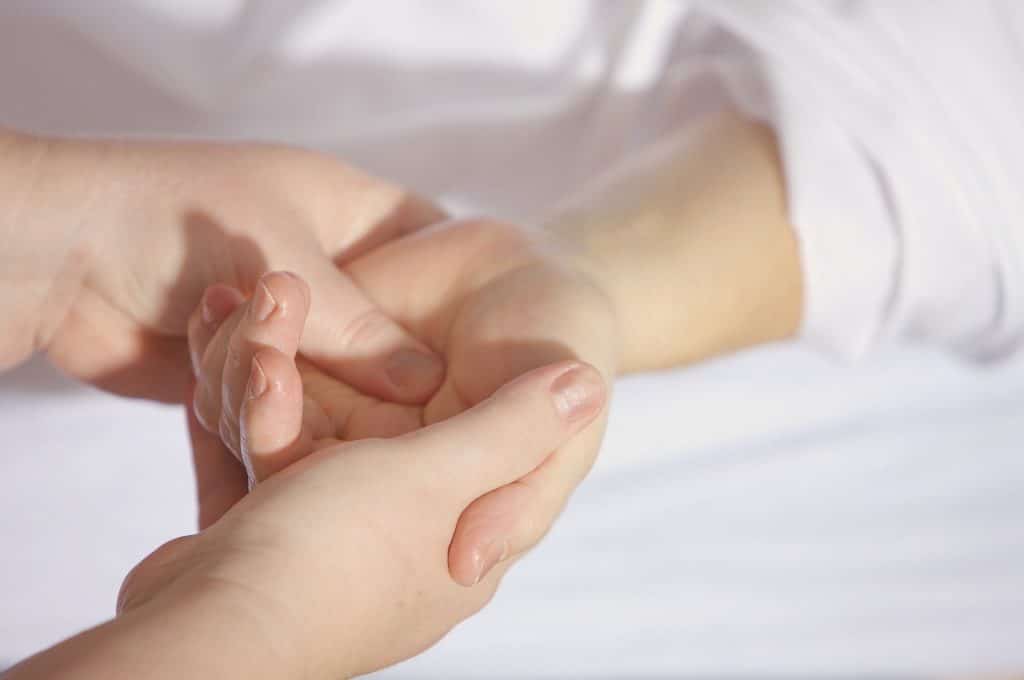 Person who's hand pain has been reduced following a chiropractic adjustment.